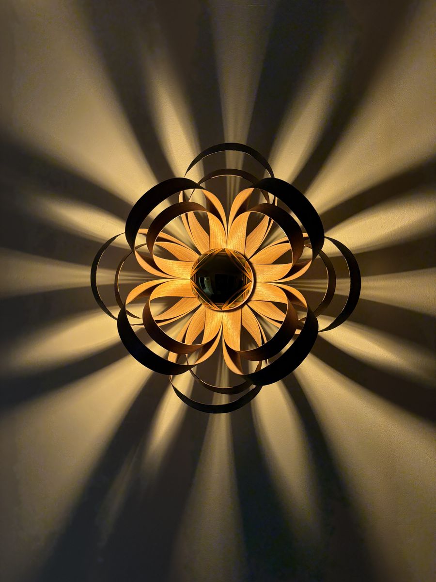 Sculptural wall light with patterned shadows installed in Bristol