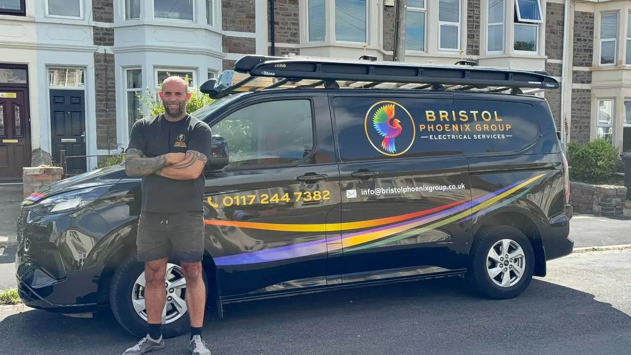 Luke, owner of Bristol Phoenix Group, with the company's liveried electrician van in Bristol